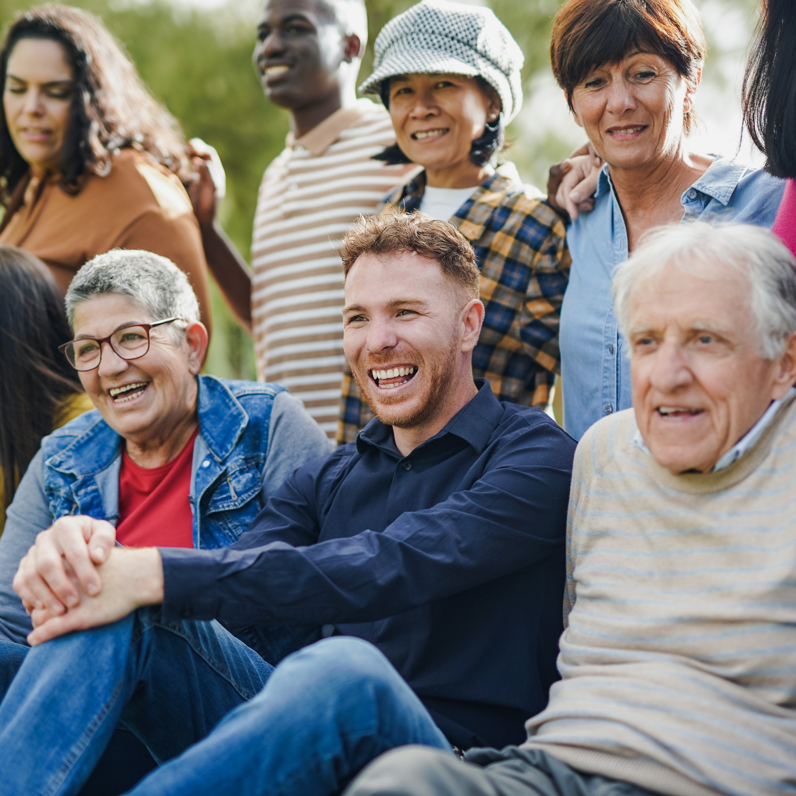 Mixed group of people range of ages and races, smiling and laughing 