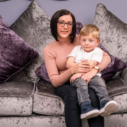 Lisa Alton and son on sofa