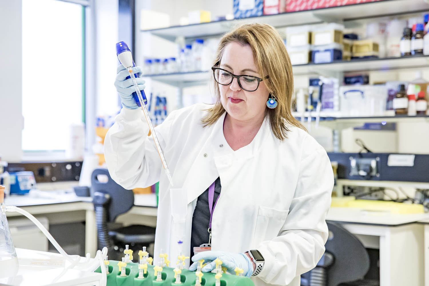 Researcher Amanda Carr in laboratory with syringe 