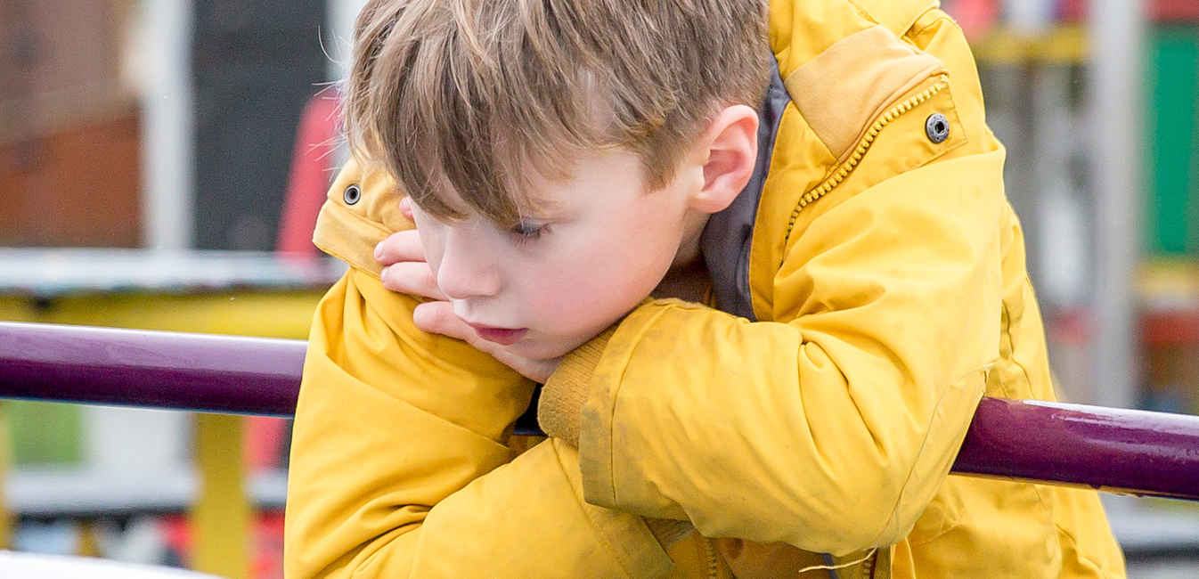 Boy looking sad in Yellow Jacket