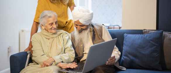 Family looking at laptop