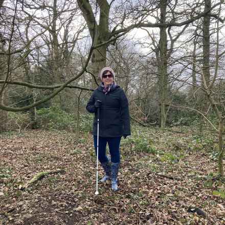 Louise in woodlands with stick