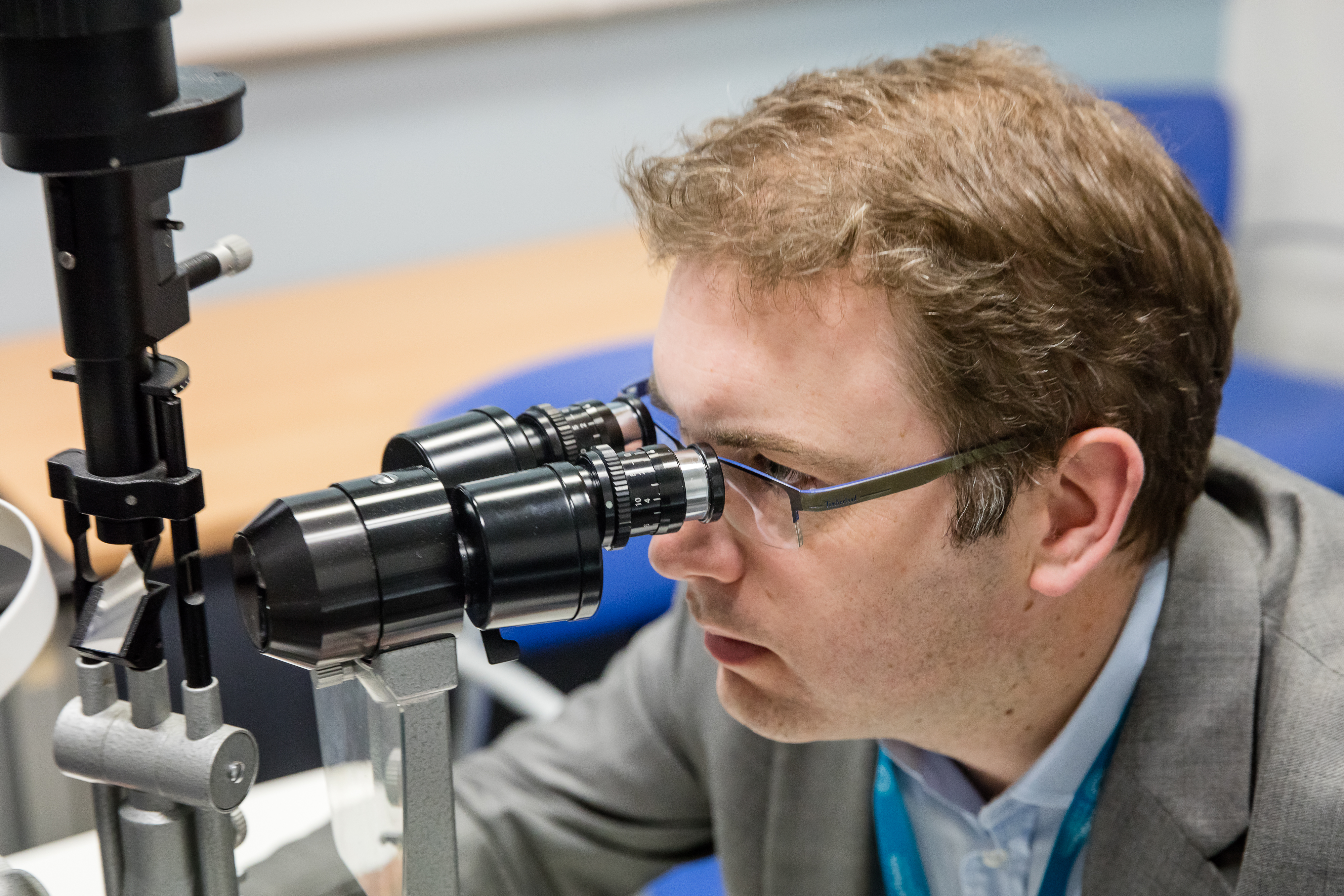Pearse Keane looking into a microscope