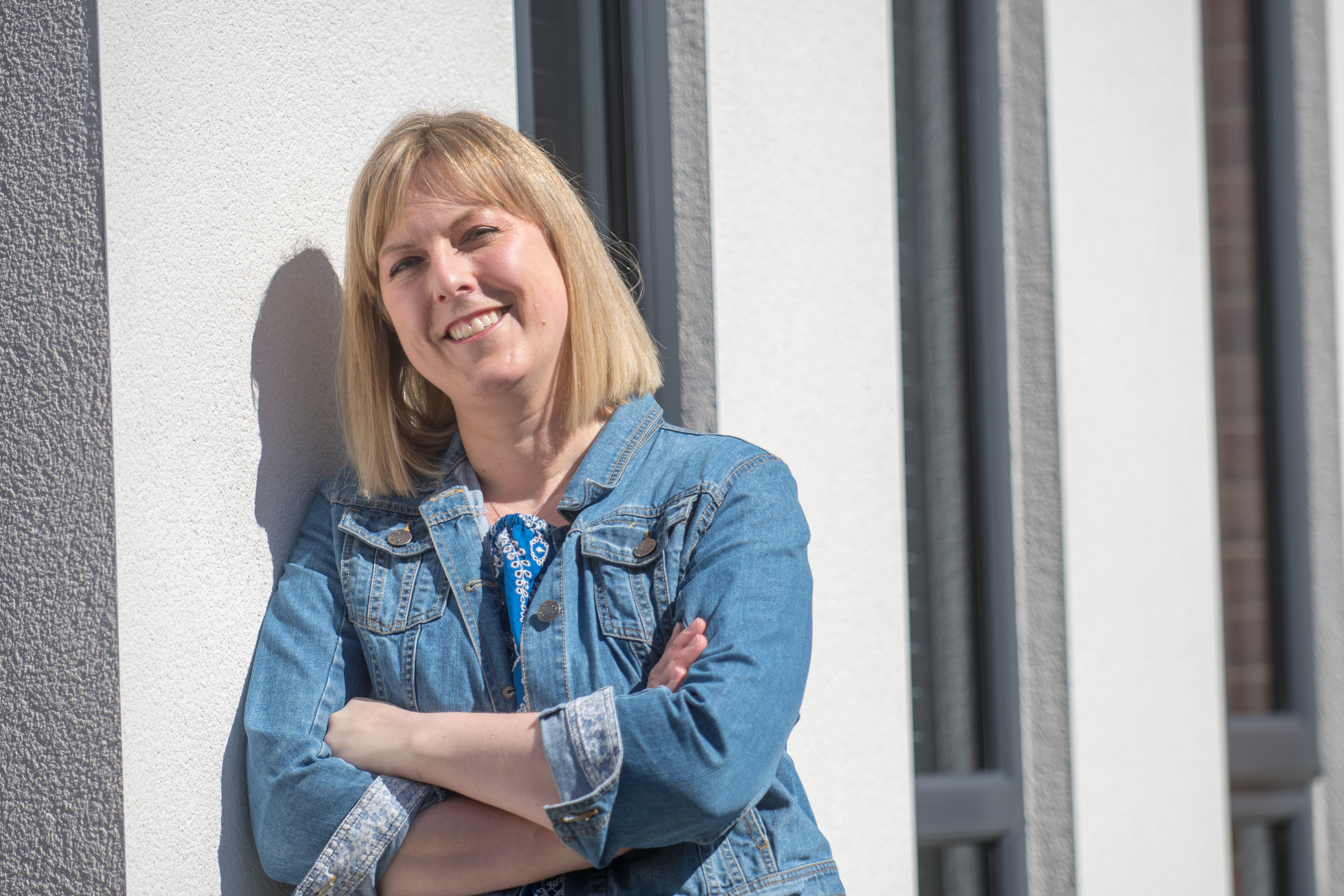 lady in denim jacket smiling