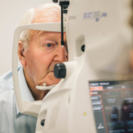 Elderly man having eye test