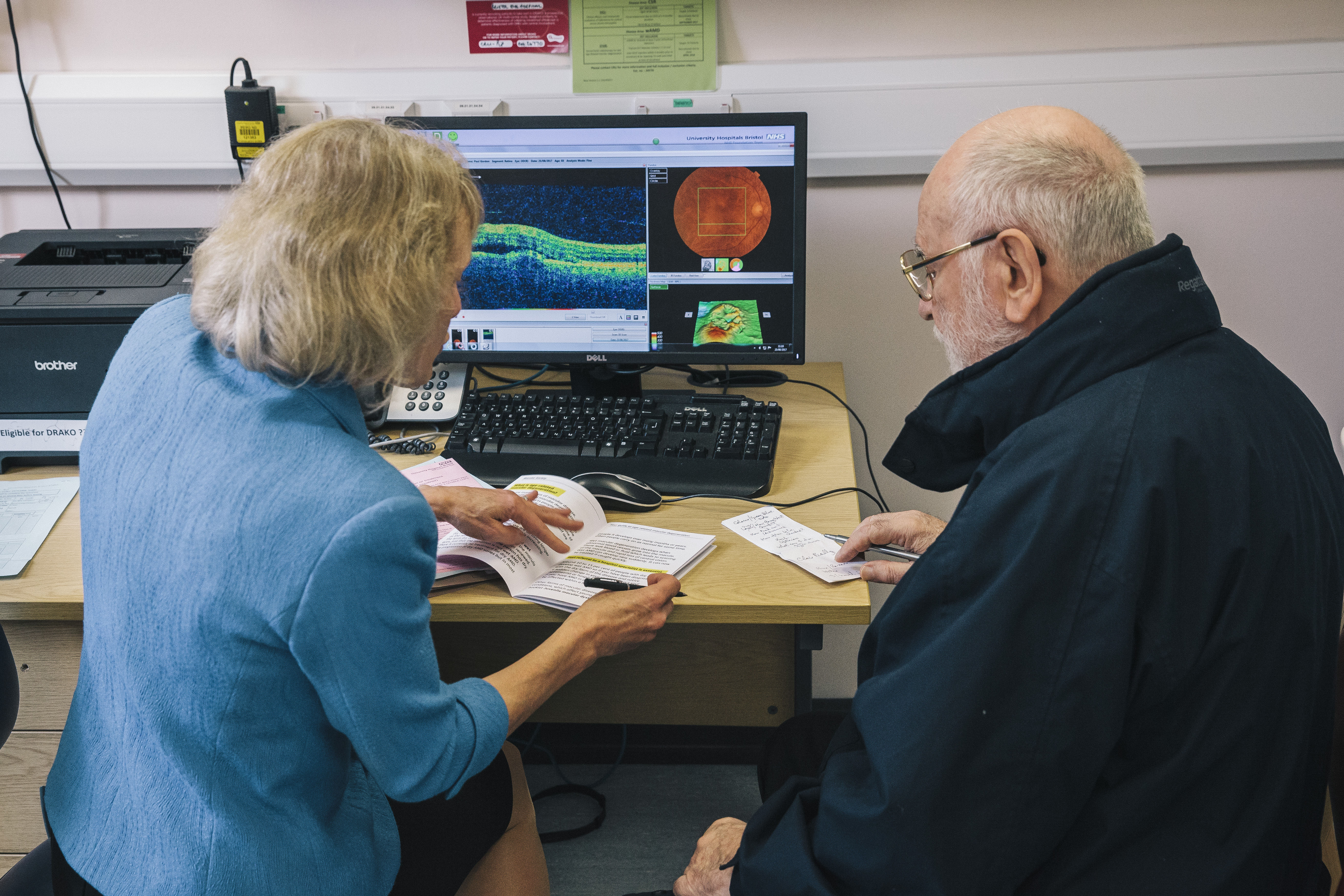 Female consultant, discussing results with male patient with computer images of results.