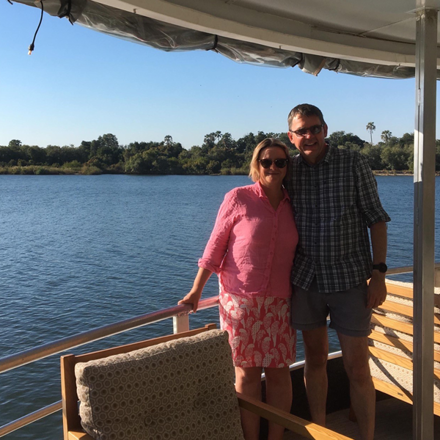 Lisa and James Cashmore smiling by lake