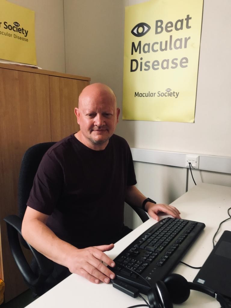 Staff member smiling at desk