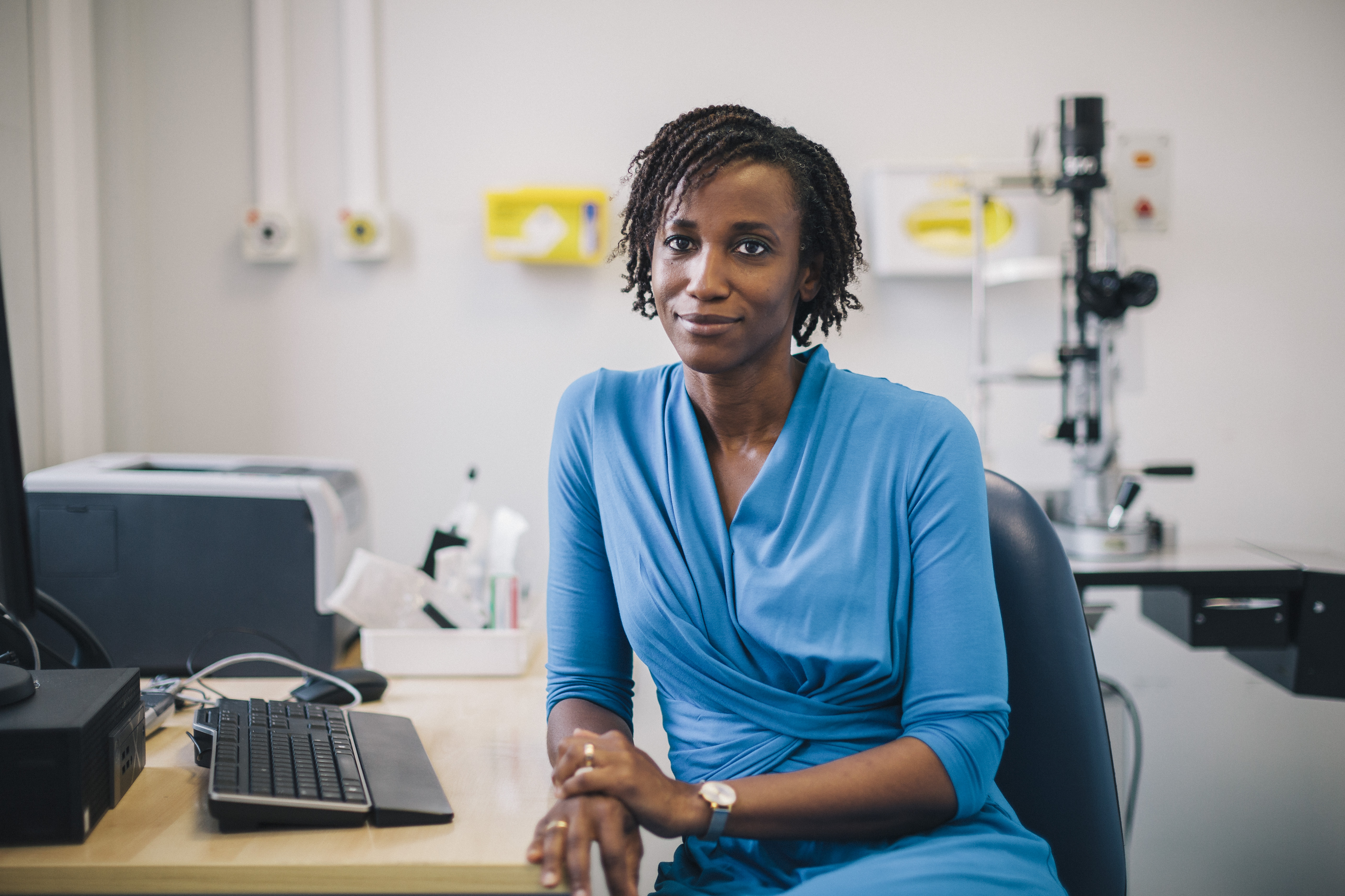 Female consultant, leaning one arm on desk.