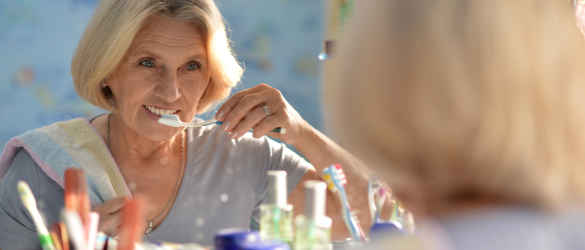 lady brushing teeth at home