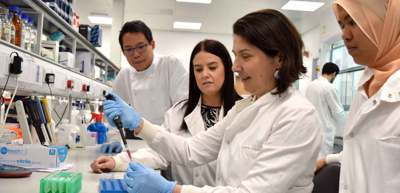 Dr Luminita Paraoan in the laboratory doing a demonstration 