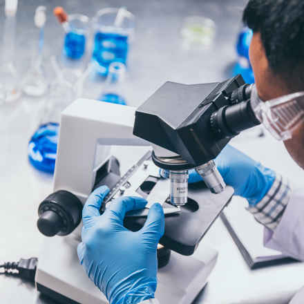 Researcher with a microscope