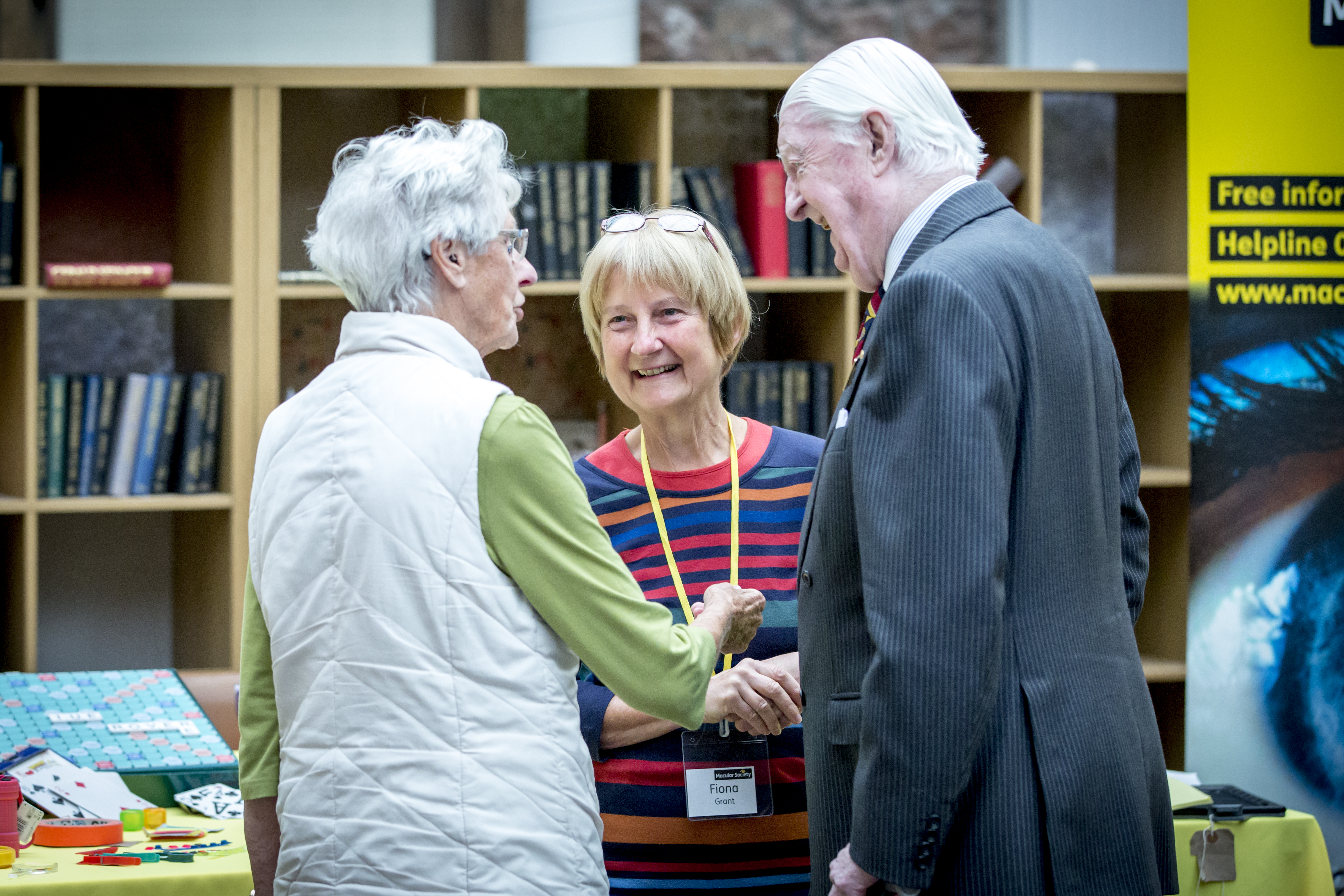 Three elderly individuals talking
