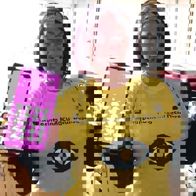 Step Around the World - Lisa Fisher in Macular Society t-shirt with phone