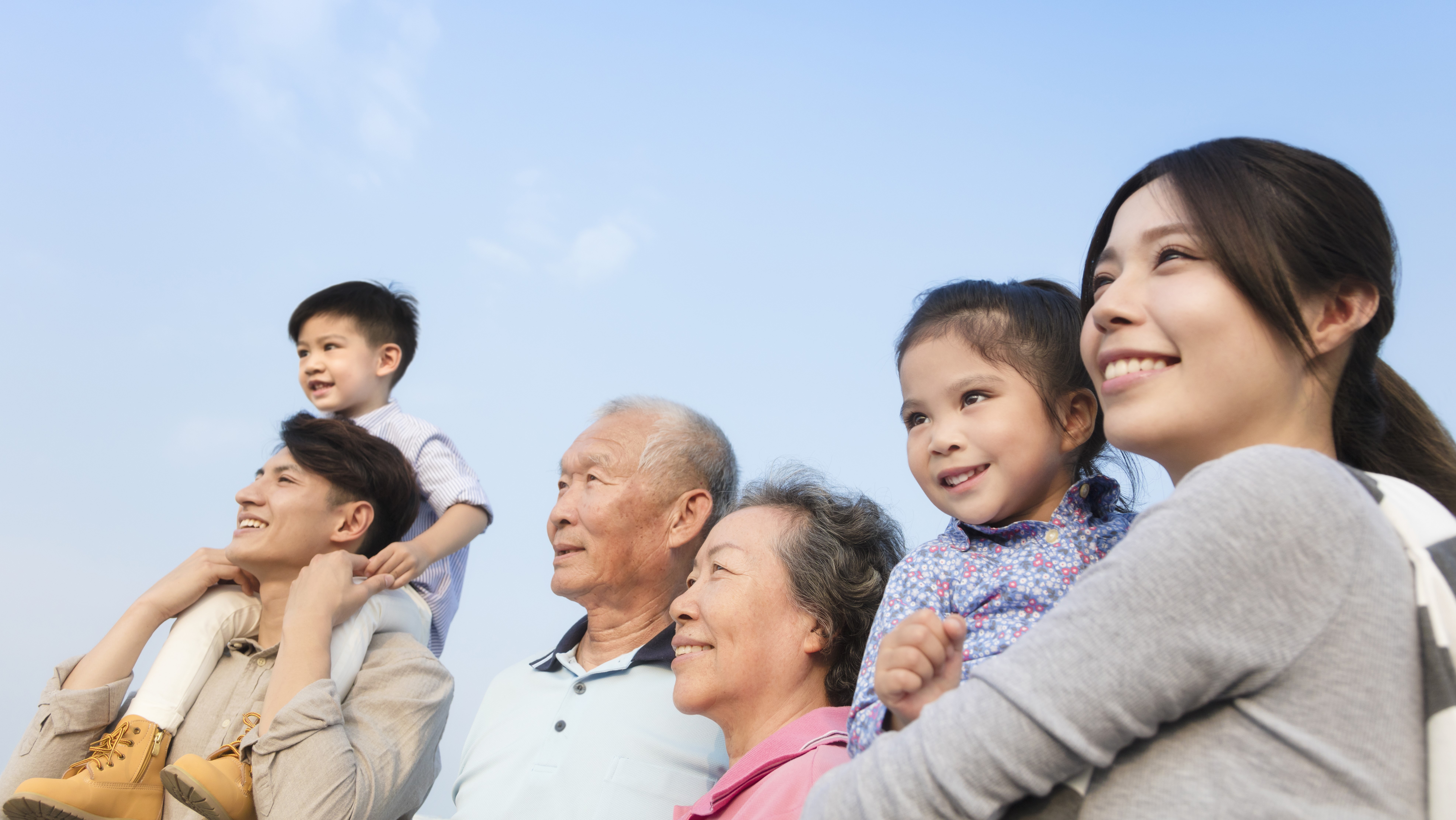 Family multigeneration looking at sky