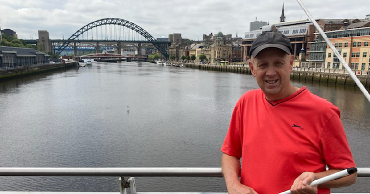 Peter Bennetts standing on bridge over river