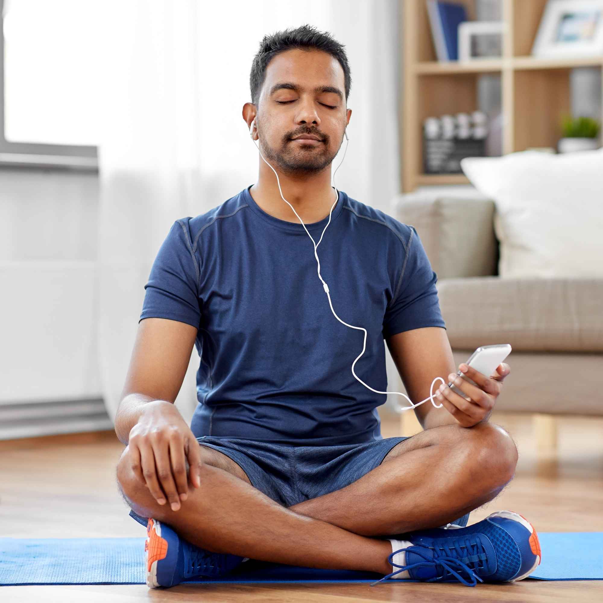 Man listening to an ipod and meditating mindfulness