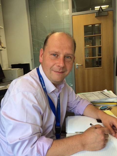 James Whiteford in office making notes