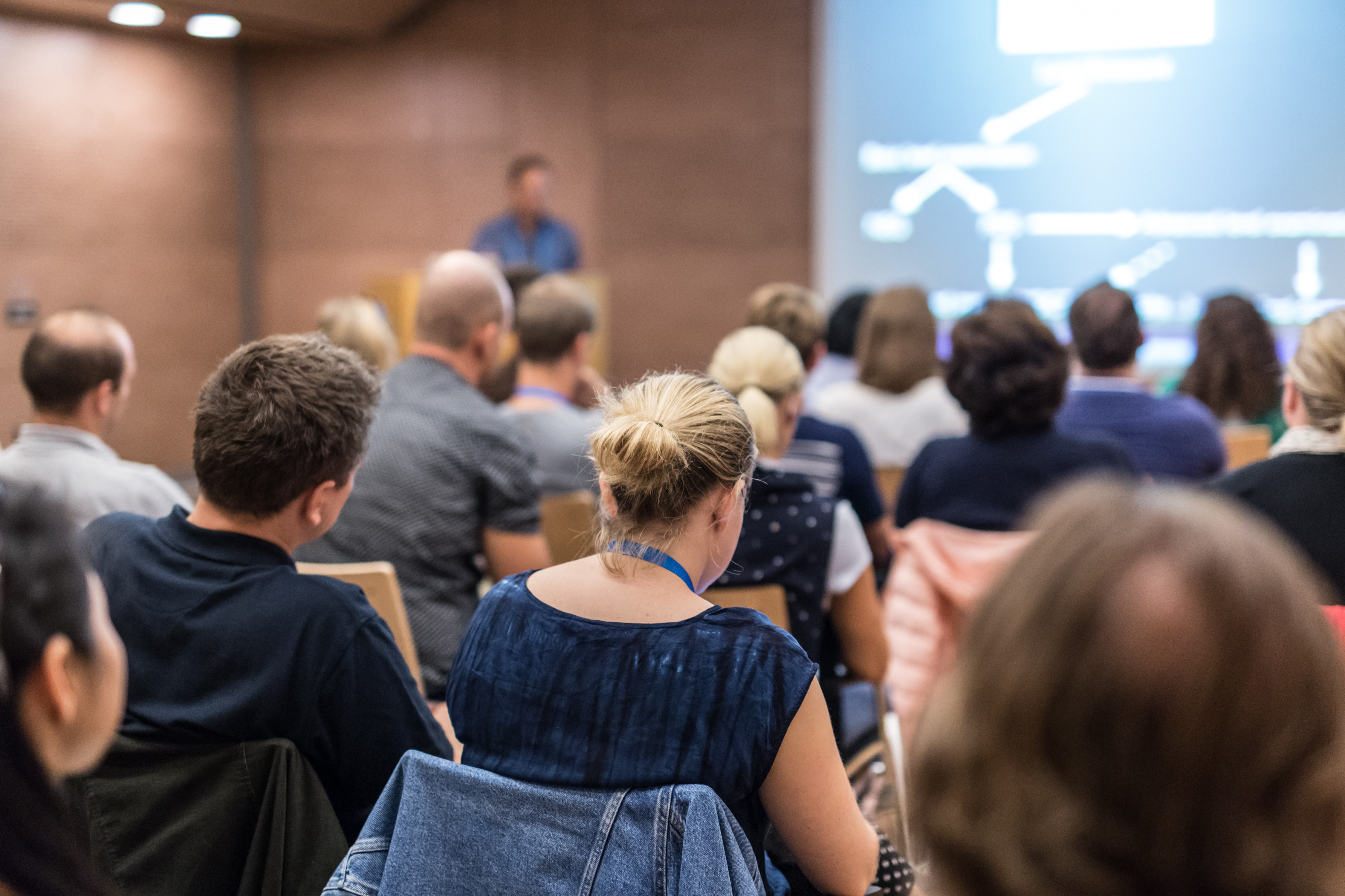 people seated looking at a projector