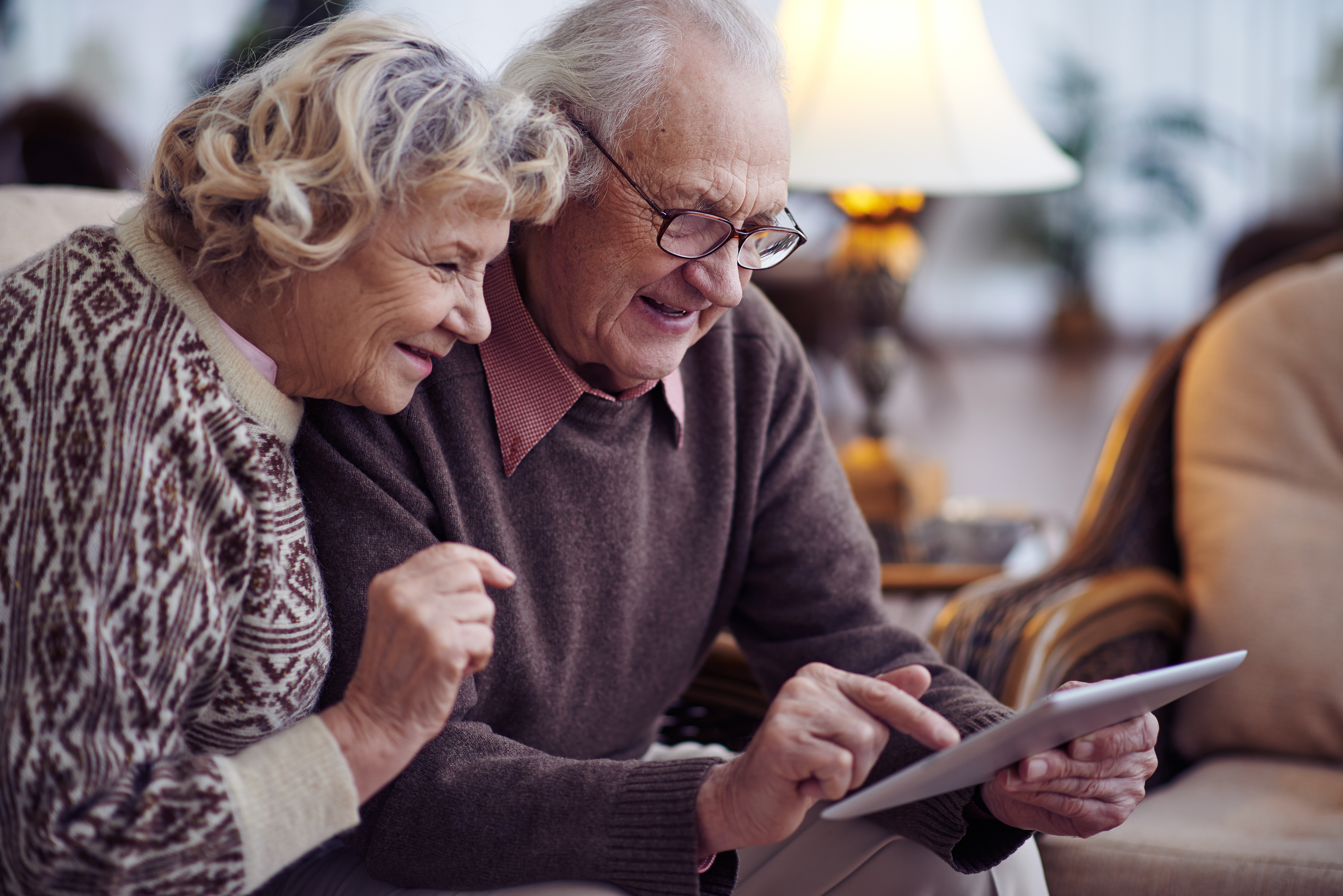Elderly couple looking at a tablet