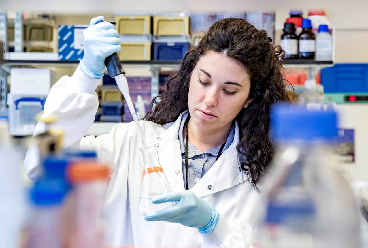 Researcher using beaker