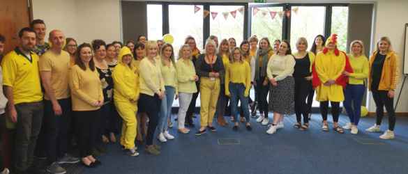 regional office tea event, group smiling at camera